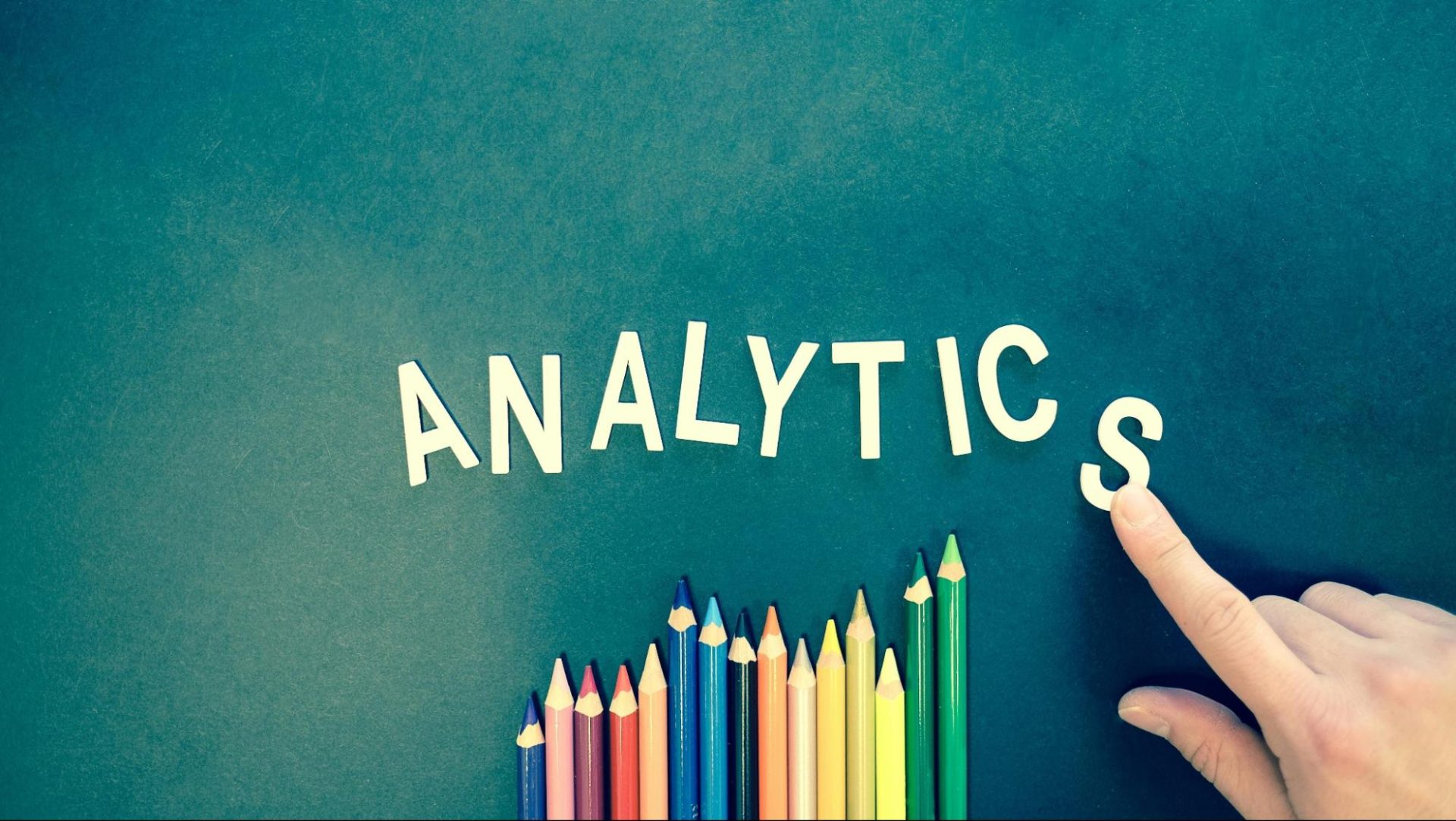 Analytics text onboard above colored pencils
